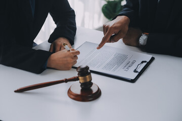 Justice and Law concept. Legal counsel presents to the client a signed contract with gavel and...