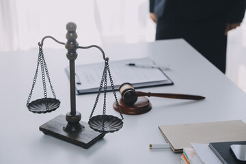 Justice and Law concept. Legal counsel presents to the client a signed contract with gavel and...
