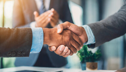 hands in a business office setting shaking hands confidently