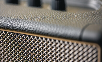 Square music speaker, control knobs, close-up details.