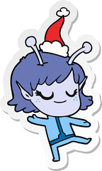 smiling alien girl sticker cartoon of a wearing santa hat