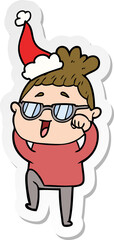 sticker cartoon of a happy woman wearing spectacles wearing santa hat
