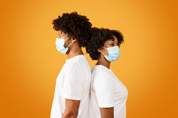 African american man and woman wearing face masks