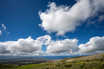 Valley on big island with big clouds