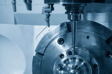 The 5-axis CNC milling machine  cutting the automotive part with solid ball end mill tool in the...