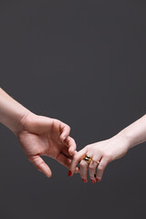Elegant Touch: A Connection of Two Hands Adorned with Rings