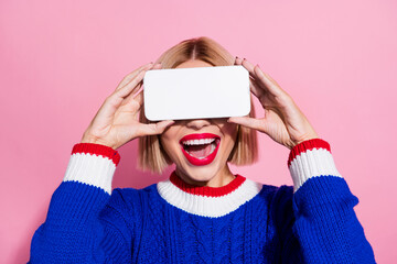 Closeup photo of young woman joking hiding her face behind smartphone making personal qr code display isolated on pink color background