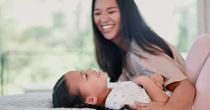 Home, bed and mother with girl, funny and happiness with love and bonding together. Family, bedroom and single parent with mama and daughter with humor and tickle with laughing, cheerful and smile