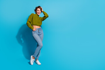 Full length photo of gorgeous cute girl wear trendy outfit standing empty space isolated on cyan color background - obrazy, fototapety, plakaty