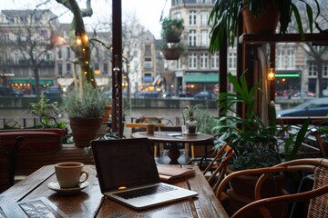 Naklejka premium Coffeehouse workspace with a laptop open for business, a fresh cappuccino ready to sip, amidst a backdrop of casual city life through the window. view to the bustling streets, blending productivity