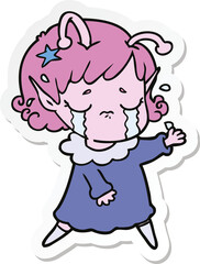 sticker of a cartoon crying alien girl