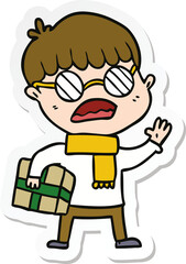 Obraz premium sticker of a cartoon boy holding gift and wearing spectacles