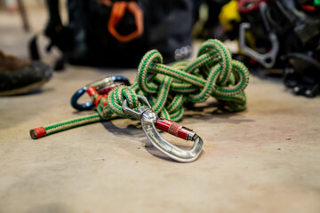 Alpinist green colored rope knots with carabiner system