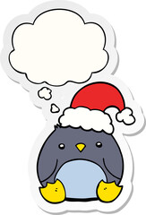 cute cartoon penguin wearing christmas hat and thought bubble as a printed sticker