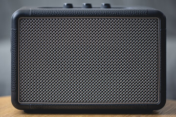 Square music speaker, metallic mesh texture close-up.