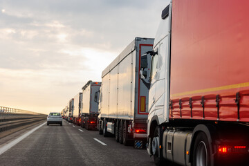 Queue of Trucks on Ukraine-Poland Border traffic jam at Sunset During Protest Roadblock. Business agricultural Logistics blockade action. Cargo lorry semi-trailers stuck