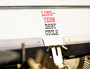 Long-term debt cycle symbol. Concept words Long-term debt cycle typed on beautiful old retro typewriter. Beautiful white background. Business Long-term debt cycle concept. Copy space.