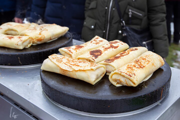 Street food. Fried pancakes in a street cafe.