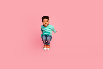 Full body photo of cute little boy jump playful have fun wear trendy aquamarine clothes isolated on...