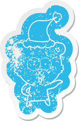 laughing teddy  bear cartoon distressed sticker of a wearing santa hat