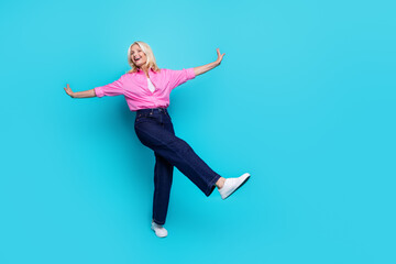 Full length photo of lovely senior lady stretch hands fly dressed stylish pink smart casual garment isolated on aquamarine color background