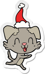 laughing sticker cartoon of a dog wearing santa hat