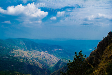 Fototapeta premium Beautiful Green Mountains and valleys of Lansdowne in the district of Garhwal, Uttarakhand. Lansdown Beautiful Hills. The beauty of nature on the hills of Uttrakhand.