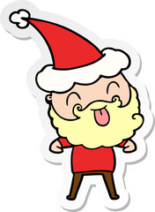 man with beard sticking out tongue wearing santa hat