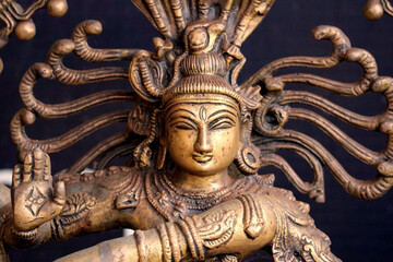   Bronze deity of dancing Shiva close-up.  Portrait of a Hindu God.