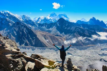 Acrylic prints Makalu A Trekker celebrates reaching the summit of 5350 m high Gokyo Ri providing grand stand views of the Highest mountain peaks on Earth - Everest,Lhotse,Makalu, Cho Oyu and the Ngozumpa glacier in Nepal