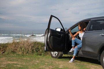 A young black woman holding her car key during a relaxing getaway to the coast. Asturias, Spain. - 751568818