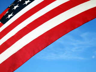 Close-up of the red stripes of the American flag against a blue background, f