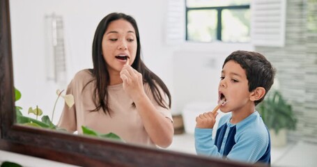 Mother, child and brushing teeth in bathroom with mirror, morning routine and dental with toothpaste for fresh breathe. Health, self care with woman and boy bonding for oral hygiene at family home