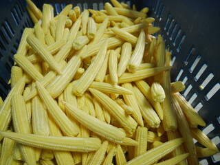 Various forms of baby corn in containers