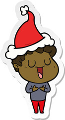 laughing sticker cartoon of a man wearing santa hat