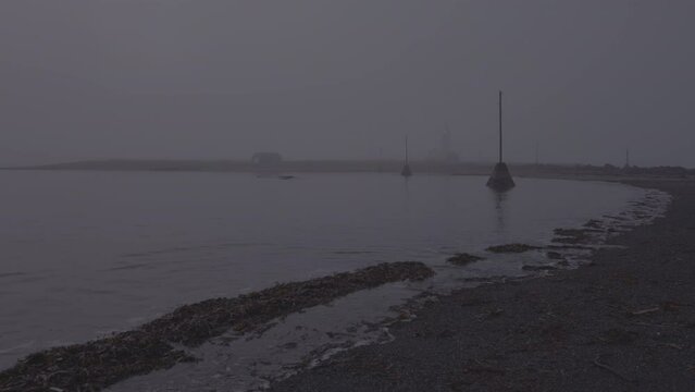 Grotta lighthouse in moody dense ocean fog,  Reykjavik Iceland