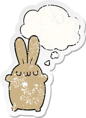 cartoon rabbit and thought bubble as a distressed worn sticker