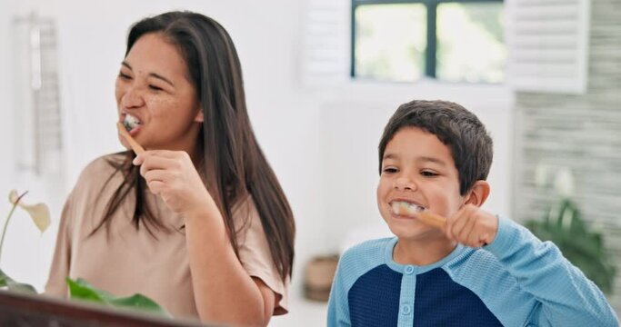 Mother, boy and brushing teeth in bathroom with mirror, morning routine and dental care with toothpaste for fresh breathe. Health, self care with woman and kid bonding for oral hygiene at family home