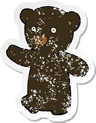 retro distressed sticker of a cartoon black bear cub