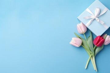 A heart-shaped gift box with tulips on a bright blue background.