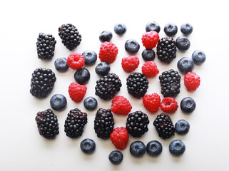 Various fresh berries isolated on white background. Raspberry, Blueberry, Blackberry.