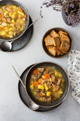 Oyster mushroom soup in plates, soup made from Pleurotus mushrooms and potatoes, carrots and spices, top view, copy space