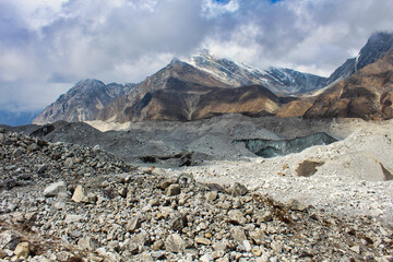 Ngozumpa Glacier, Nepal's largest glacier with massive debris, stone, ice and clay deposits, flows from Cho Oyu and is the headwaters of the Dudh Kosi that travels over 1500 kms to the Bay of Bengal - obrazy, fototapety, plakaty