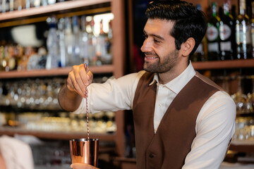 Man bartender is making a drink and dancing at bar. Dance party with group people dancing . Women and men have fun and drinking martini cocktail in night club.