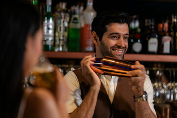 Man bartender is making a drink and dancing at bar. Dance party with group people dancing . Women and men have fun and drinking martini cocktail in night club.