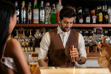 Man bartender is making a drink and dancing at bar. Dance party with group people dancing . Women and men have fun and drinking martini cocktail in night club.