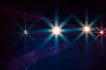 Dark blue stage background with rays of light from spotlights.