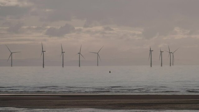 Burbo Bank Offshore Wind Farm seen from Formby beach with clouds in background