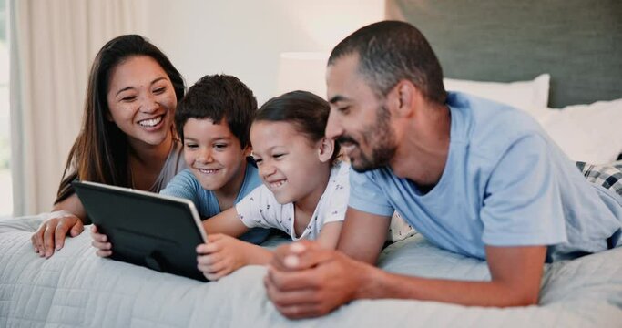 Tablet, smile and family on bed in home, learning or watch funny cartoon for bonding together. Technology, happy kids and parents in bedroom on internet for streaming app, laughing and game to relax