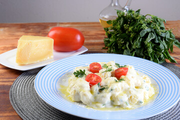 Gnocchi with white béchamel sauce, typical Italian pasta potato food